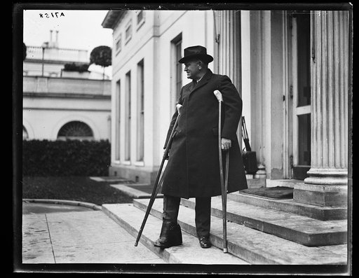 Edwin Denby with crutches. White House, Washington, D.C.