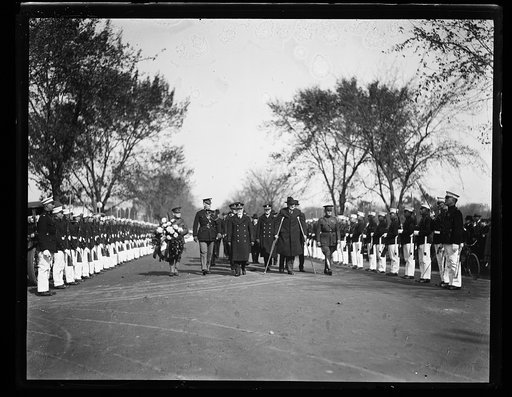 Military procession; includes Edwin Denby on crutches