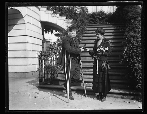 Grace Coolidge and unidentified man with crutches at White House, Washington, D.C.