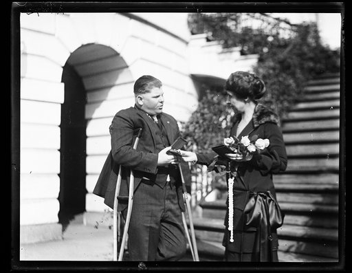 Grace Coolidge and unidentified man with crutches at White House, Washington, D.C.