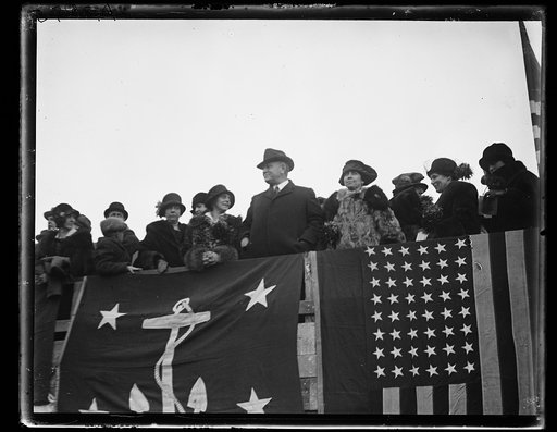 Group; includes Edwin Denby and Grace Coolidge in stadium stands