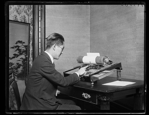 Man operating a typewriter for Japanese characters
