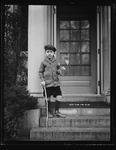 Boy with flower on steps of Woodrow Wilson House, Washington, D.C.