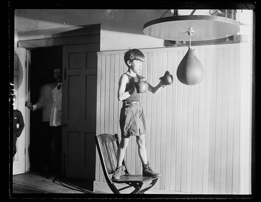 Teddy Roosevelt, Jr., son of the Asst. Secy. of the Navy, punching the bag at the gymnasium at the Racquet Club