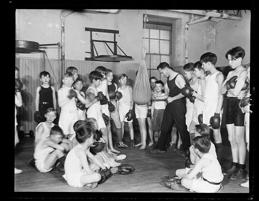 Wm. R. Whipp, Physical Instructor at the Racquet Club in Wash., demonstrating art of self-defense to sons of Dip. and Sen. [...