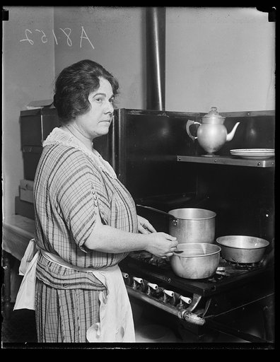 Woman at stove in kitchen