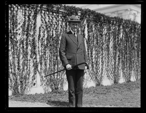 Pres. Coolidge snapped on one of his daily walks sporting a "big stick," the gift of A. J. Shell of Wise County, Va. [White House, Washington, D.C.