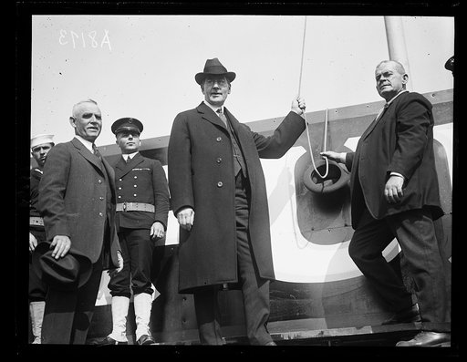 Secy. of Navy, Curtis D. Wilbur, raising the flag on Amer. League lot, April 15, before the official opening of the baseball season in Washington