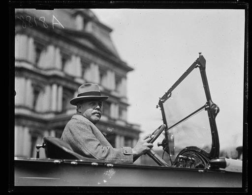 Nicholas Longworth in automobile; State, War and Navy building in background, Washington, D.C.