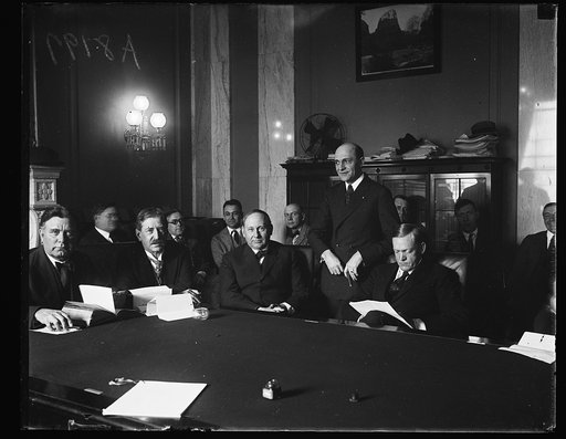 Group at table, left to right, seated: William E. Borah, Hubert Work?, Joseph T. Robinson, and Charles McNary