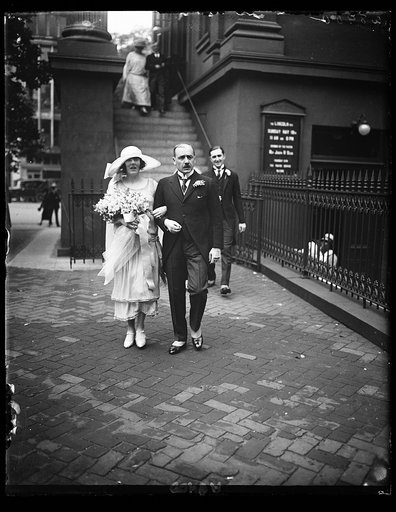 Mr. Walker Turnheer, Counselor and Charge d'Affaires of Swiss Legation in Wash., Best Man, and Miss Ruth Wallace, Maid of Honor and sister of the bride, leaving church after wedding of Miss Mary Wallace and Dr. Chas. Bruggmann, First Secy. of Swiss Legation