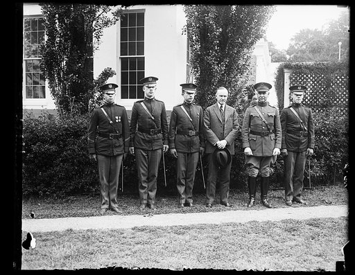 Committee from the high school cadets with Pres. Coolidge, Lt. Col. Ford W. Sammis, Lt. Col. C.M. Irelan, L.P. Baird, Pres Coolidge, Col. W.M. Craigie, USA, Pro. of Military Tactics of the High School Cadets, and Lt. Col. C.N. Hisle [White House, Washington, D.C.