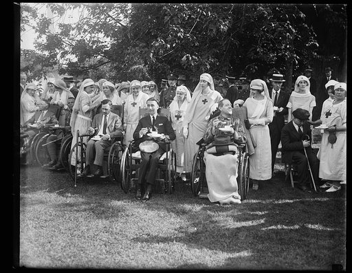 Mrs. Sylvanus Stokes, Jr., and Mrs. Elridge Jordan, with some of the wounded soldiers whom they assisted at the garden party given in honor of the veterans at the W.H. [i.e., White House] June 5th
