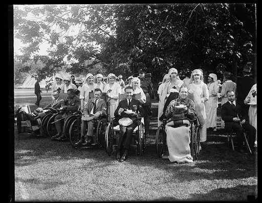 Mrs. Sylvanus Stokes, Jr., and Mrs. Elridge Jordan, with some of the wounded soldiers whom they assisted at the garden party given in honor of the veterans at the W.H. [i.e., White House] June 5th