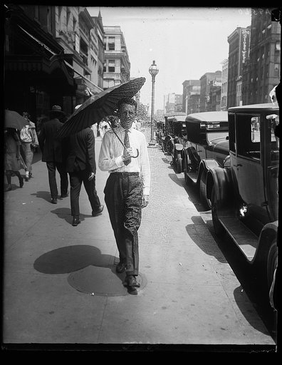 With Wash. melting under the hottest day of the year, Russell T. Edwards of the Amer. Tree Assn. starts a new style for men by throwing his hat away and carrying a chinese parasol. He carries it on the golf course too