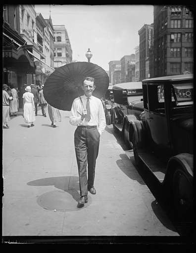 With Wash. melting under the hottest day of the year, Russell T. Edwards of the Amer. Tree Assn. starts a new style for men by throwing his hat away and carrying a chinese parasol. He carries it on the golf course too