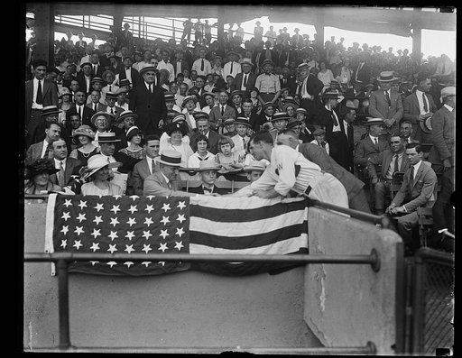 Pres. Coolidge congratulating Stanley Harris, mgr. of the Wash. ball team on bringing the team home at the head of the league. In the photo are the Pres's two sons and Mrs. Coolidge