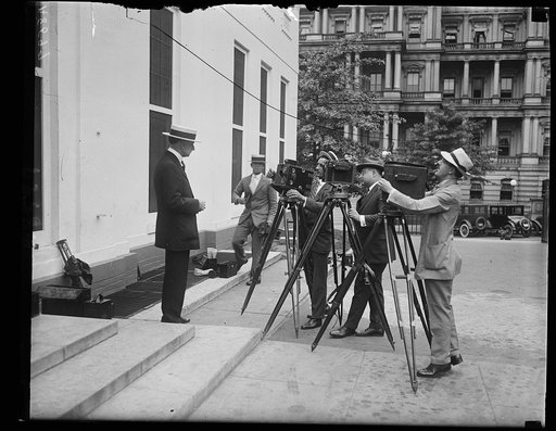 Charles G. Dawes at White House with cameramen