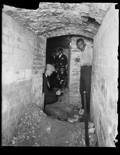 Men in tunnel or cellar space