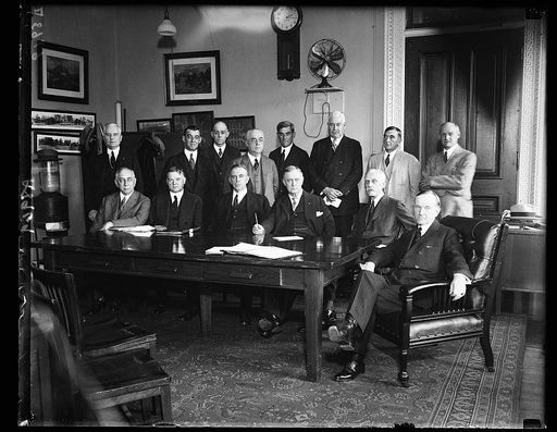 Group: includes, at table, center to right: Herbert Hoover, Hubert Work, Harry S. New, Andrew W. Mellon, and Calvin Coolidge