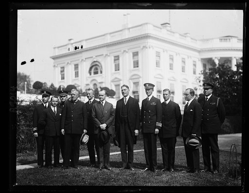 "Columbus disciples of the air," who safely brought the ZR-3 to the U.S. for Germany, at the White House, Oct. 16th by Pres. Coolidge. L to r: Lt. Com. S.M. Kraus, H.C. Flemming, Col. E.C. Turner, Dr. Hugh Eckener, who commanded the flight, E. Van Schiller, Pres. Coolidge, Secy. of the Navy Wilbur, 