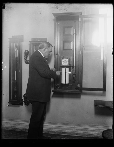 Prof. Chas. F. Marvin, Chief of U.S. Weather Bureau, with recording mercurial barograph, an instrument made and perfected by the bureau under his supervision, measuring on a magnified scale the fluctuations in the pressure of the air