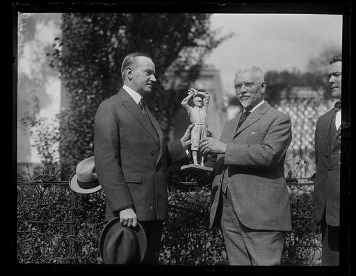 U.S.J. Dunbar, the sculptor, presents Pres. Coolidge with a statue of Walter Johnson, Hero of the Nationals [White House, Washington, D.C.