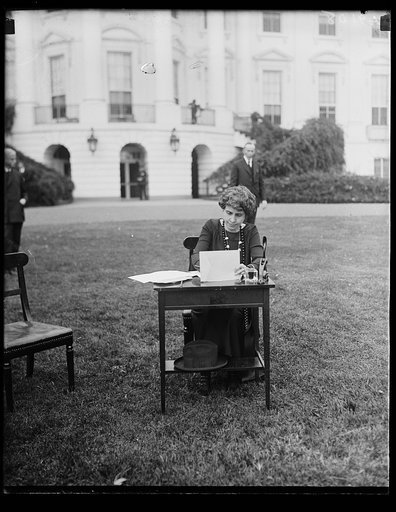 Grace Coolidge at desk outside White House, Washington, D.C.