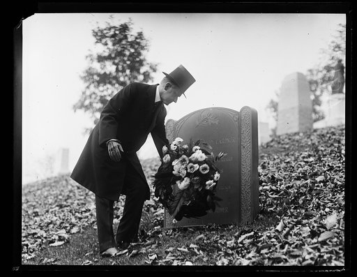 Calvin Coolidge placing flowers on Gardner tombstone