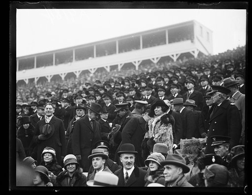 Crowd in stands; includes Curtis Wilbur, Calvin Coolidge, and Grace Coolidge