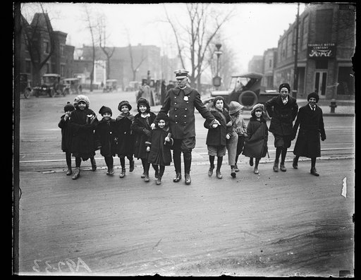 Children crossing street with police officer