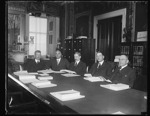 Group at table; Curtis D. Wilbur, 2nd from right