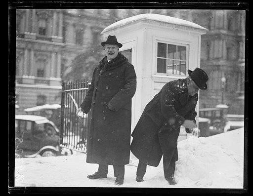 Secy. of Labor Davis and Secy. of War Weeks engage in snowball battle at W.H. during Wash. snow storm