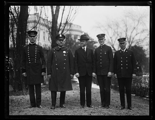 President Coolidge personally congratulates the [...] members, one each from the police and fire departments of the District of Columbia who have been decorated with gold medals for conspicuous bravery in the line of duty during 1924. Left to right: Chief of Police Daniel Sullivan, Policeman John F.