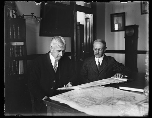To "shoot" the sun. Capt. Edward T. Pollock (left) and Capt. F.B. Littell, scientists of the U.S. Naval Observatory in Washington, will ha[...] charge of the expedition to observe the total solar eclipse of [...] sun from a giant dirigible, "Los Angeles" on Jnuary, 24th