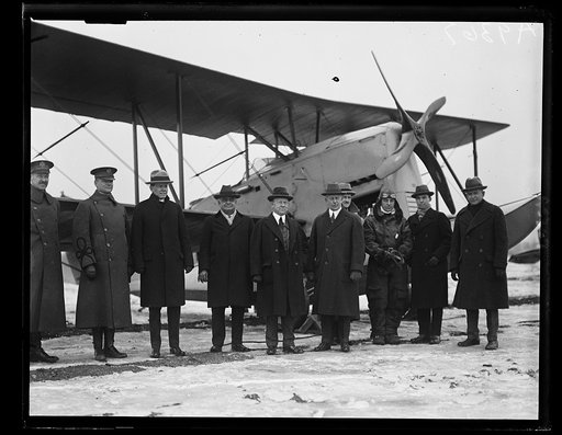 The new amphibian airplane, that is at home both [...] water and land was inspected by a Congressional Committee at Bolling Field, Monday, January 19. The machine was designed by Grover Loenig, of New York. Left to right in the group, standing before the neew plane are: Major H.B. Clagett, Commander