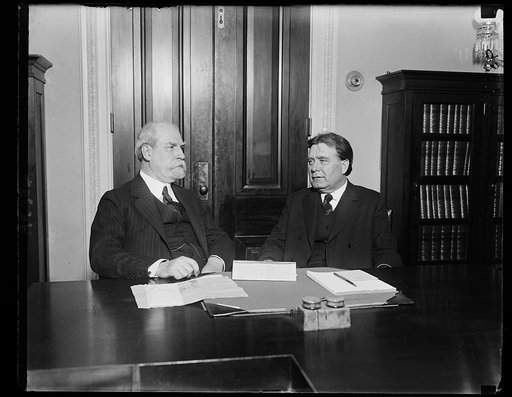 Secretary of State Charles Evan Hughes, (left), with Senator Borah, Chairman of the Foreign Relations Committee, leaving a two hour executive session on February 2, when both Secretary Hughes and Secretary Hoover were heard regarding the German Commercial Treaty, intended as a model for conventions 
