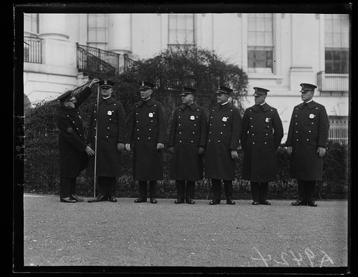 New White House police must be tall. Six new six-footers have been added to the White House police force by the Congressional Deficiency bill of last December. Regulations require that they be six feet and over. The picture shows Sergeant Dalrymple measuring R.G. Ford, a new officer, measuring 6 fee