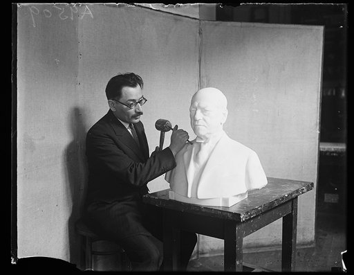Sculptor working on bust of Samuel Gompers