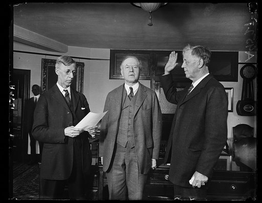 In less than 30 min. from the time he arrived at the Union Station, Wash., March 18, John G. Sargent of Vermont, was sworn in at the Dept. of Justice as Atty. Gen. of the U.S. Oath taking. C.B. Sornborger (left) Appointment Clerk delivered the oath. Rush L. Hollard, Asst. Atty. Gen., in center