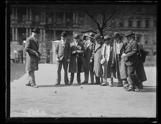 Group at White House with spinning tops; State, War and Navy Building in background. Washington, D.C.