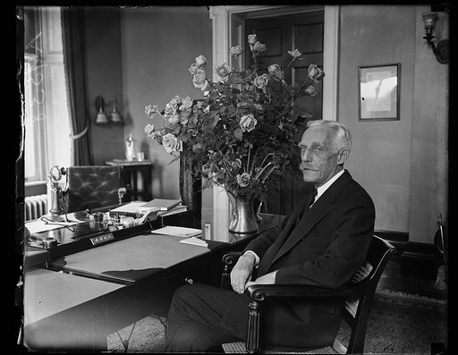 Andrew W. Mellon at desk with flowers