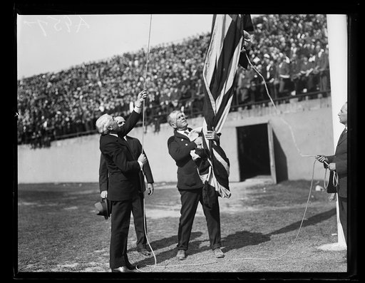 Raising/lowering flag at stadium event