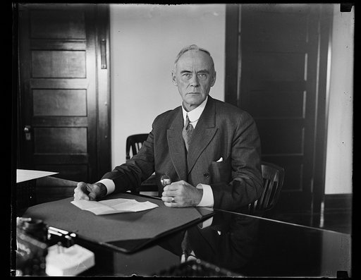 Thomas P. Woodlock of New York, member of Interstate Commerce Commission, seated at his desk. Washington, D.C.