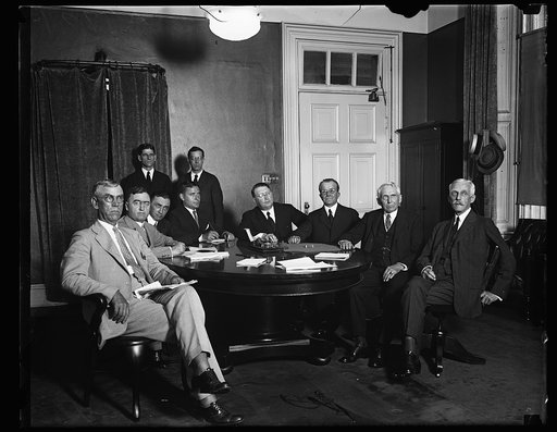 Group at table; Frank Kellogg and Andrew Mellon at right