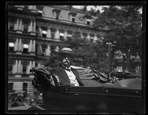 Man in automobile at White House; State, War and Navy Building in background. Washington, D.C.