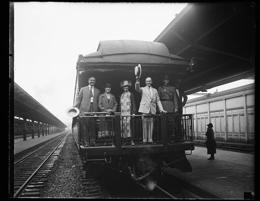 Grace and Calvin Coolidge and group on caboose of train