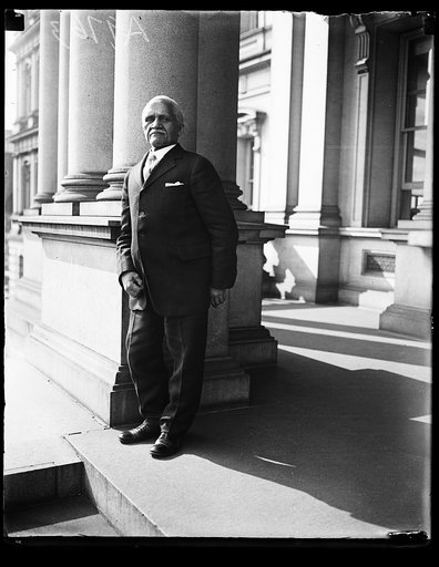 Man on steps of State, War and Navy Building, Washington, D.C.
