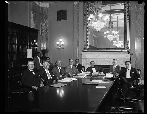 Group at table; Harry S. New, left