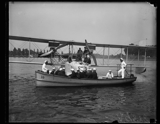 Midshipmen of the U.S. Naval Academy, (Ist year men) being carried by boat to the plane in which they take daily flights and study each and every part of the mechanism. These are the first men to receive this training under the recent orders, providing for a course in aviation